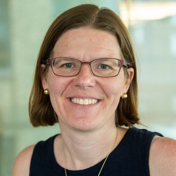Natalie Enright Jerger smiling to camera and wearing a black sleeveless shirt